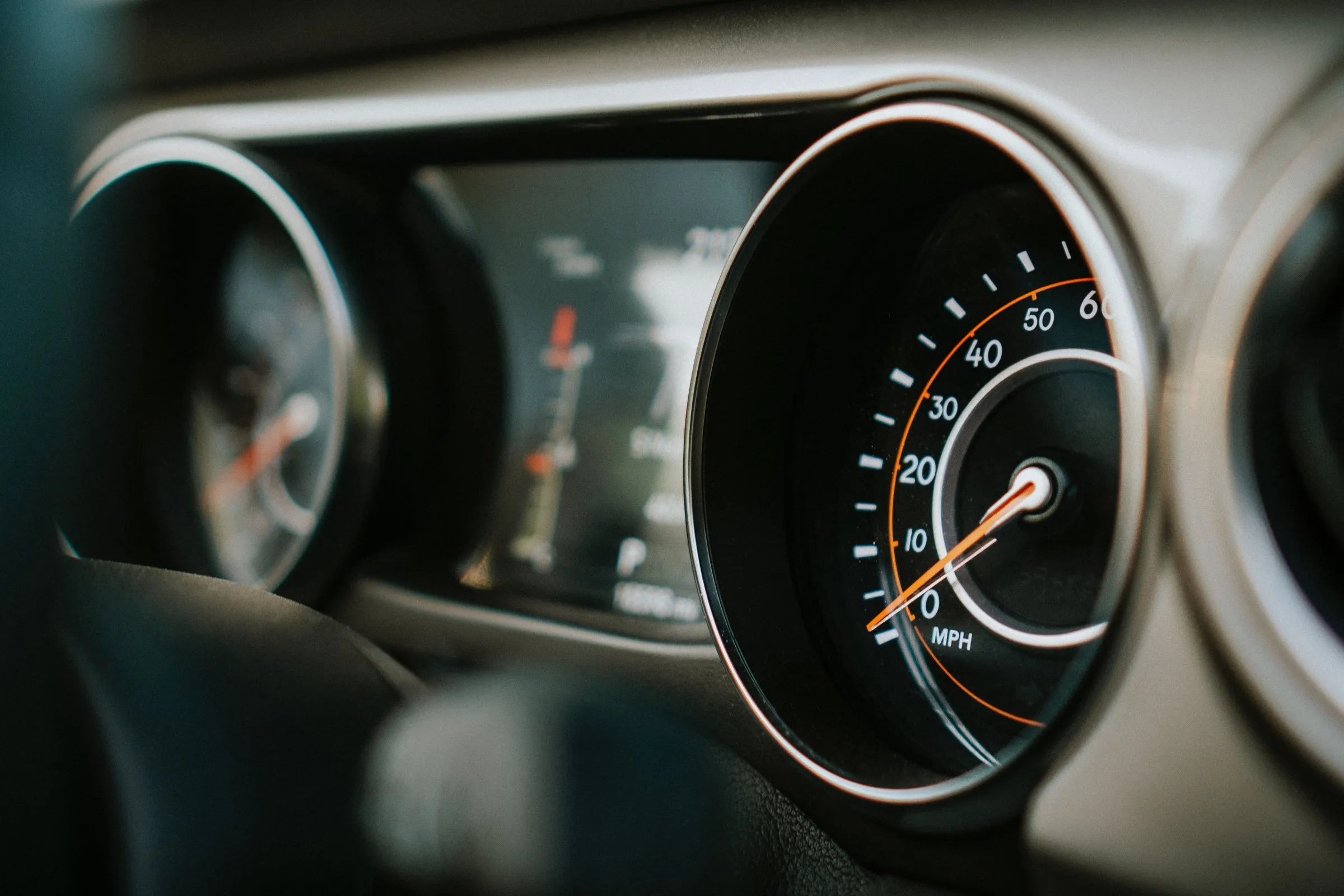 Automotive instrument cluster with speedometer gauges